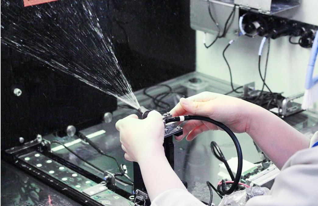 ウォッシャーノズル部品の射出検査をしている様子